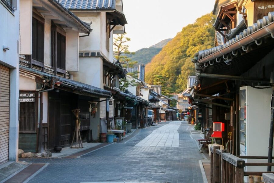 From Hiroshima: Rabbit Island and Takehara Town Tour - The small statue with a local test of luck
