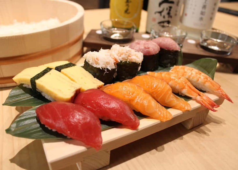 Osaka Dotonbori: Sushi Making Experience - Step two: adding neta, wasabi, and the topping