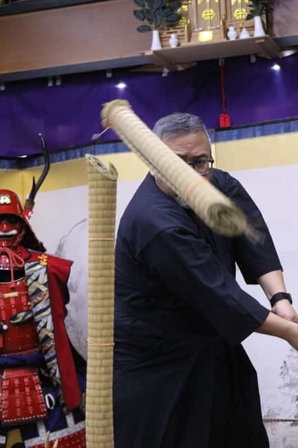 Samurai Armor & Sword experience with phot near Osaka Castle - Putting on armor and carrying the samurai image