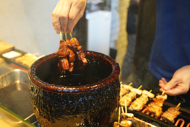 Tokyo: Local Foodie Adventure near Roppongi - Walking through a neighborhood with nearly a century of shops